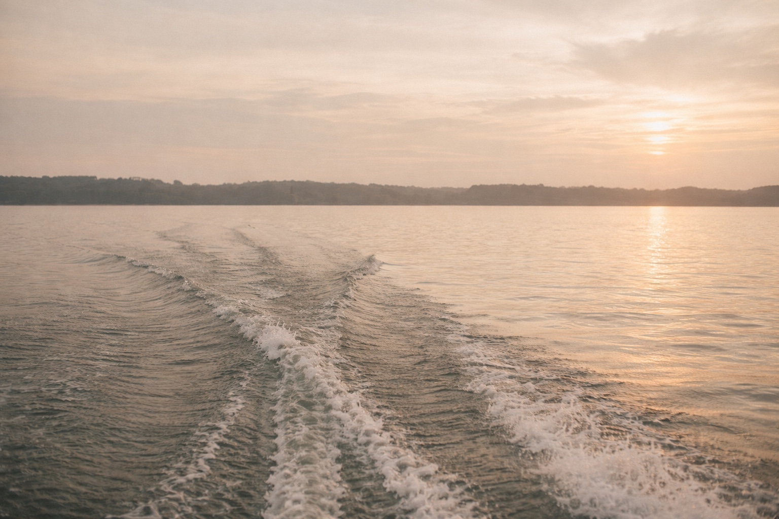 Carolina lake at sunset with boat wake