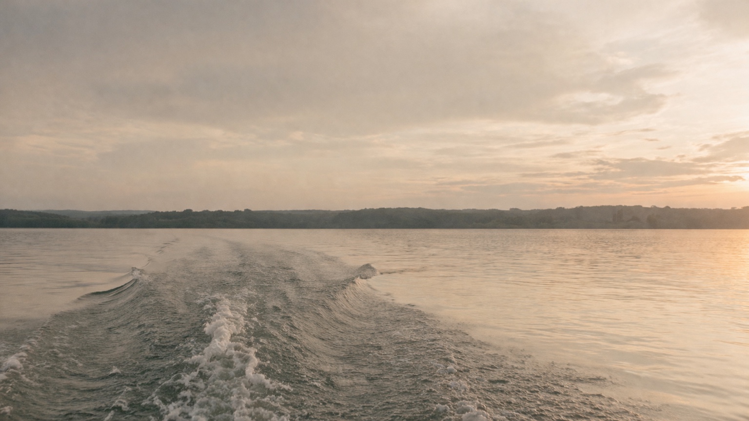 Boat on lake at sunset
