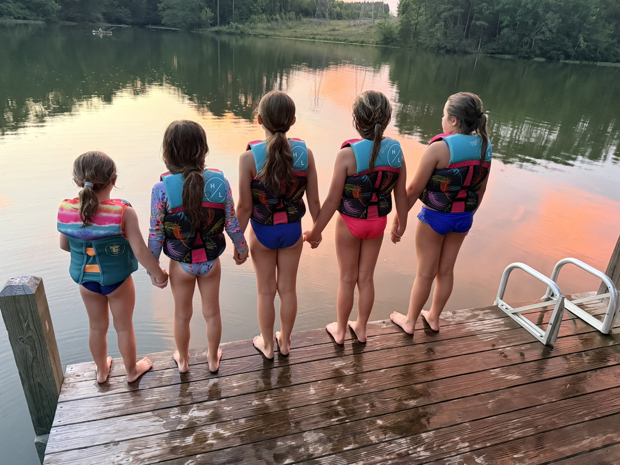 Family jumping off the dock